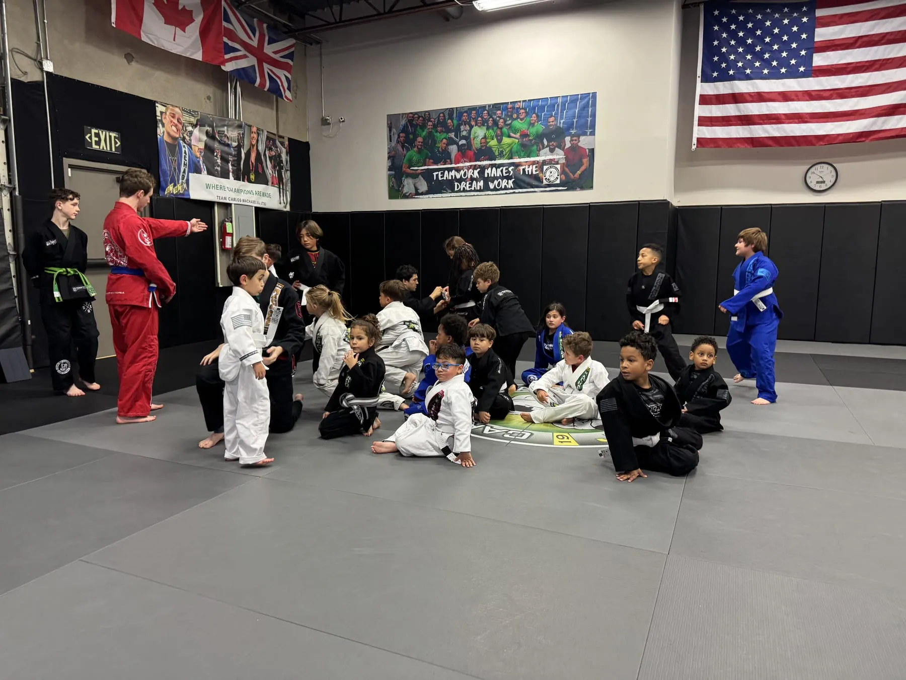 Machado Method Jaguars kids in their gis on the mat with their coach during a Jiu-Jitsu class in Carrollton, TX